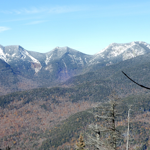 image of three mountain peaks with light snow